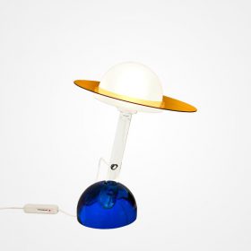 Plutone table lamp by Daniela Puppa for Fontana Arte, model 2701. Italy 1981. Clear glass stem with white diffuser fitted with amber ring, mounted in blue glass base. Sold with original certificate of authenticity. 16 inches high, 12.5 inches wide, 12.5 inches deep.